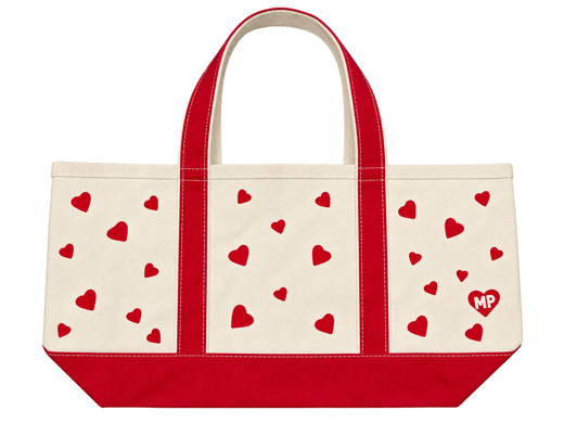 Cream canvas tote with red handles, a red base, scattered red hearts, and an MP heart emblem